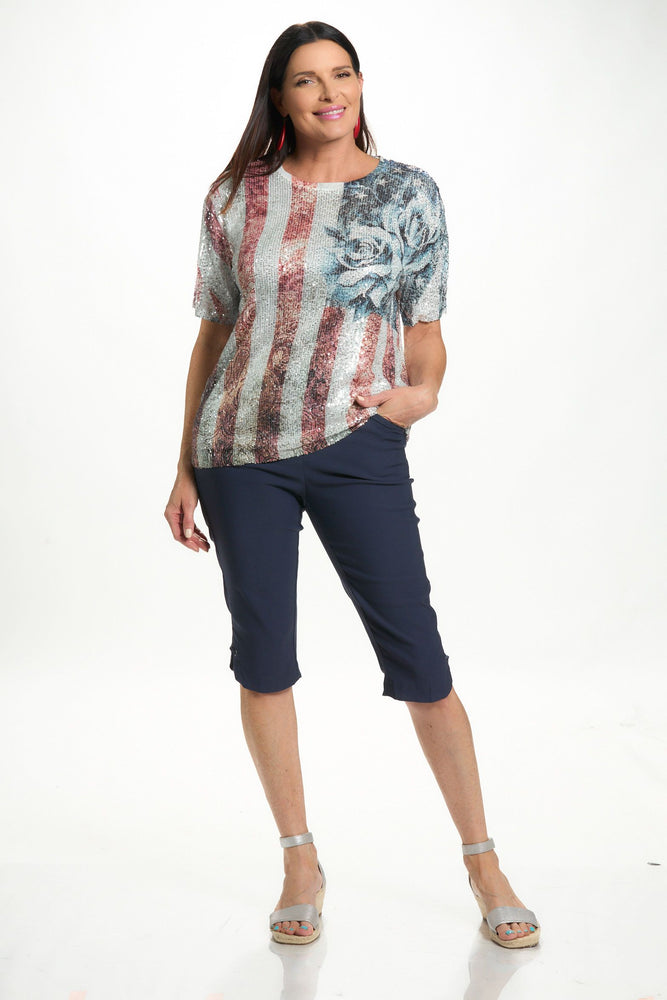 Front image of short sleeve tee with sequins in flag and rose print. 