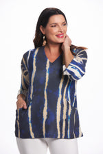 Front image of impluse bell sleeve top with pockets. Blue slanted lines print. Top with pockets. 