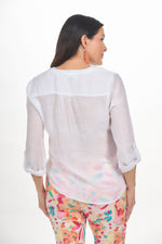 Back image of Elo white button front tie blouse. 