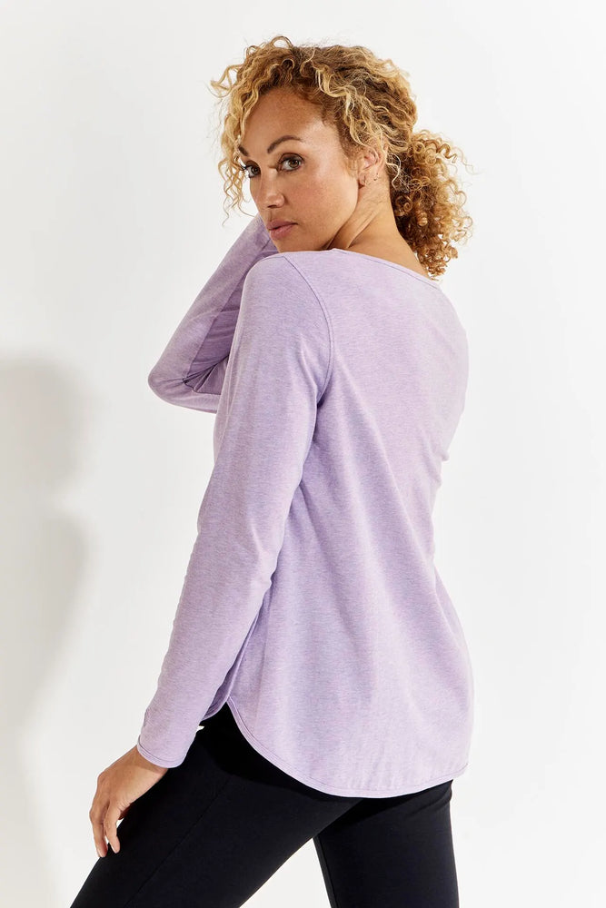 Back image of Coolibar heyday side split shirt. Soft lilac color long sleeve top. 