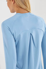 Back image of Coolibar accelera tee. Long sleeve shirt in cloud blue color. 