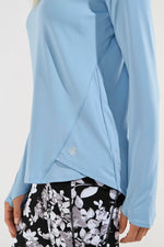 Side image of Coolibar accelera tee. Long sleeve shirt in cloud blue color. 