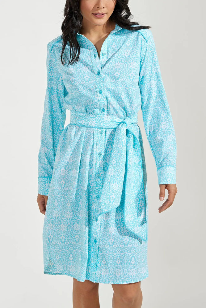Front image of Coolibar Kitts dress. Long sleeve button front dress in blue floral print. 