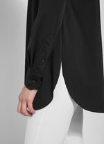 Round hem view of Lysse Shiffer button down top. Long sleeve button front black top. 