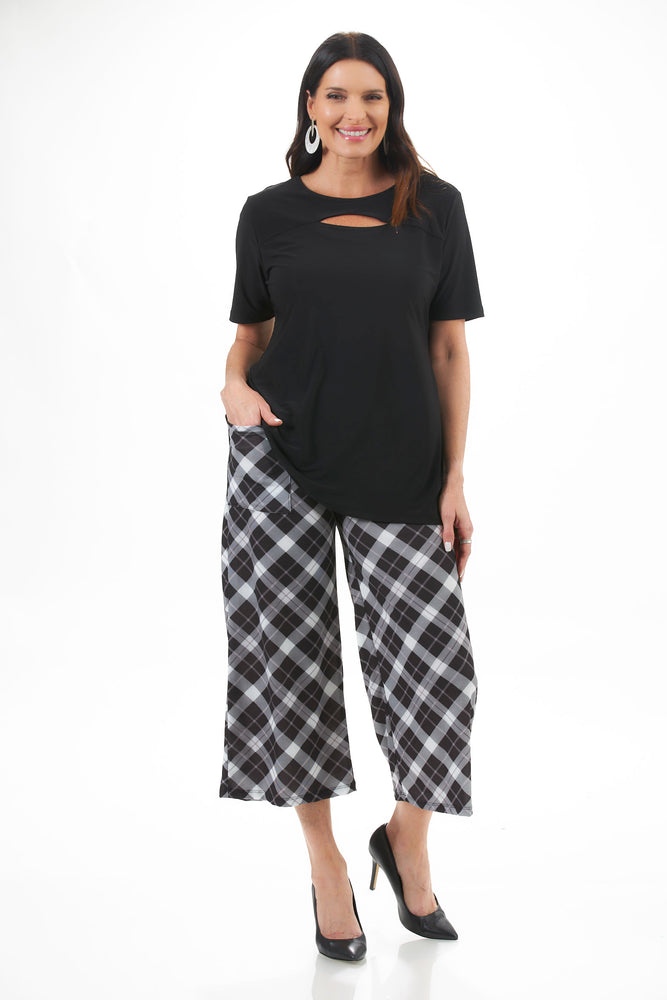 Full Body View Image of Patchington Destination Collection Black center cutout Tunic, paired with the gaucho black/white plaid. Destination Collection - Center Cutout 1/2 Sleeve Tunic