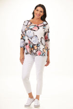 Front image of 3/4 sleeve parachute texture hem tunic. Multi printed white top. 