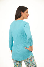 Back image of shana crinkle tee shirt in turquoise. Half sleeve v-neck crinkle top. 