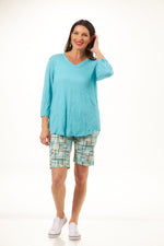 Front outfit image of shana crinkle tee shirt in turquoise. Half sleeve v-neck crinkle top. 