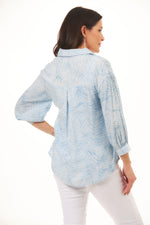 Back image of Fashion Cage high low button front collar shirt. Blue geometric print. 