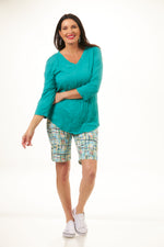 Front outfit image of shana crinkle top. Half sleeve v-neck crinkle top in jade. 