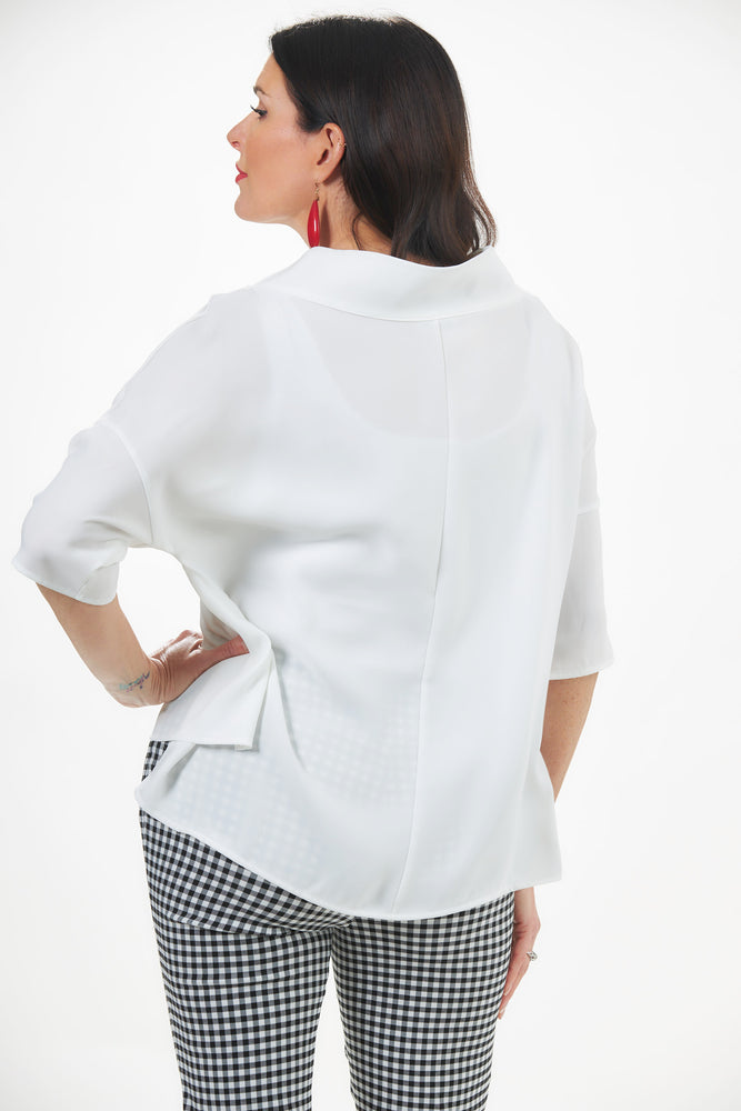 back image of woman in white cowl neck top with asymmetric hem perfect for date night