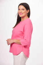 Side image of lulu b 3/4 sleeve scoop neck top. Hot pink rounded hemline top. 