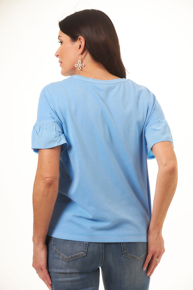 Back image of tribal frill crew neck top. Blue short sleeve top. 