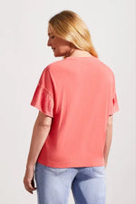 Back image of short sleeve melon paint tribal top. 